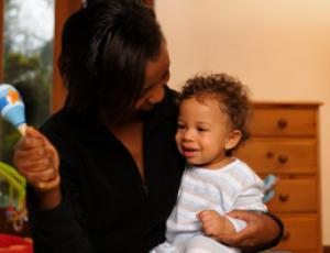 child smiling at caregiver